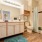 Large well lit bathroom with white accents 
