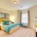 Large well lit bedroom with plush carpets and large windows 