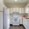 Spacious and well lit kitchen with wood flooring and stainless steel appliances