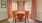 Large dining room with wood floors and large windows 