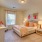Large well lit bedroom with plush carpets and large windows 