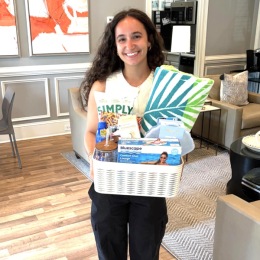 a woman holding a basket of items